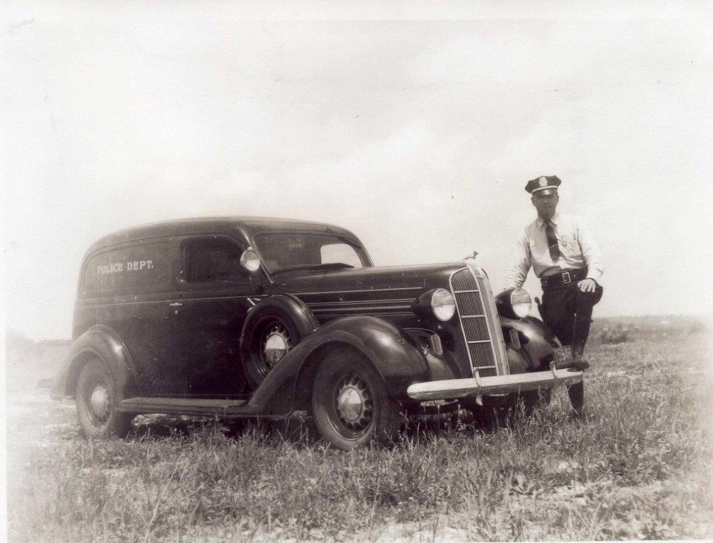 1930s police cruiser and officer