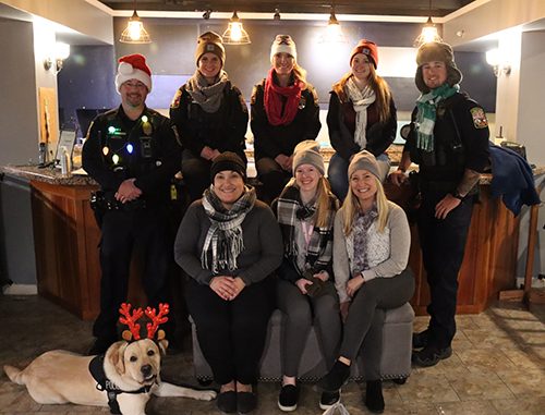 Winchester Police Officers pose with a K9 in winter hats